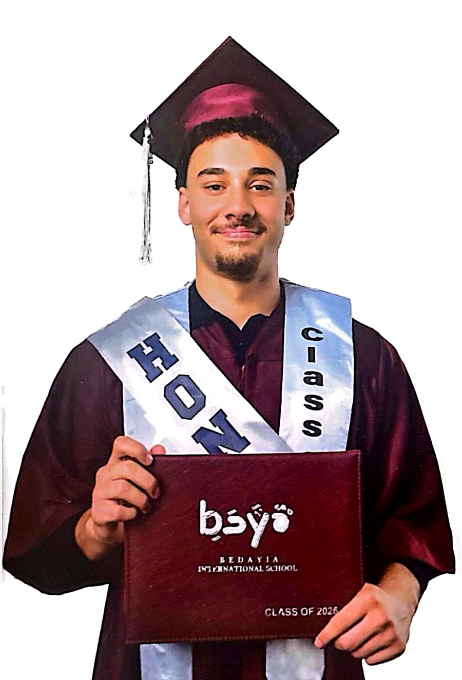 Salman Fakhry in cap and gown, holding his Bedayia International School diploma.